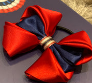 Luxury Bows: Rich red satin bows with Navy central design