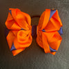 Luxury Bows: Orange and navy bows with twist design