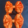 Luxury Bows: Orange bows with twist design