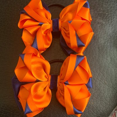 Luxury Bows: Orange and navy bows with twist design