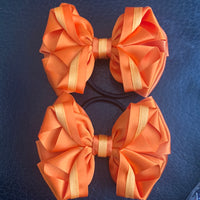 Luxury Bows: Orange bows with twist design